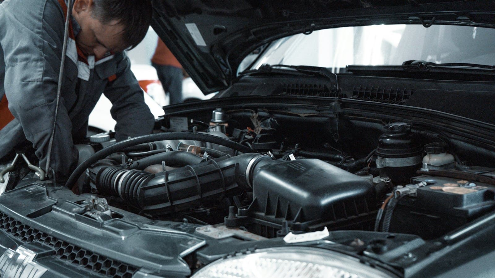 A mechanic checking an engine bay